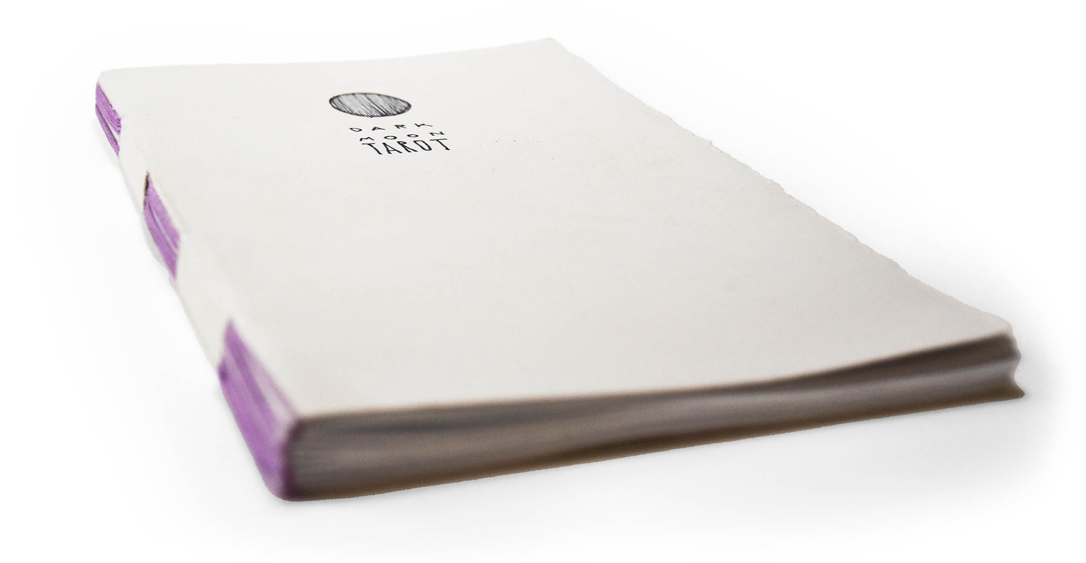 a hand bound booklet with purple binding floss lays stretched out on a white background, it's beautiful